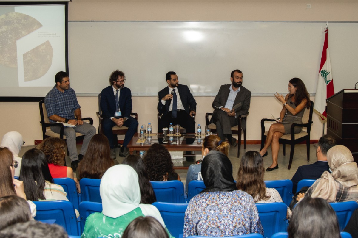 Panelists speaking in front of the audience.