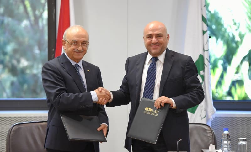 LAU President Mawad shakes hands with the head of the Lebanese Customs.