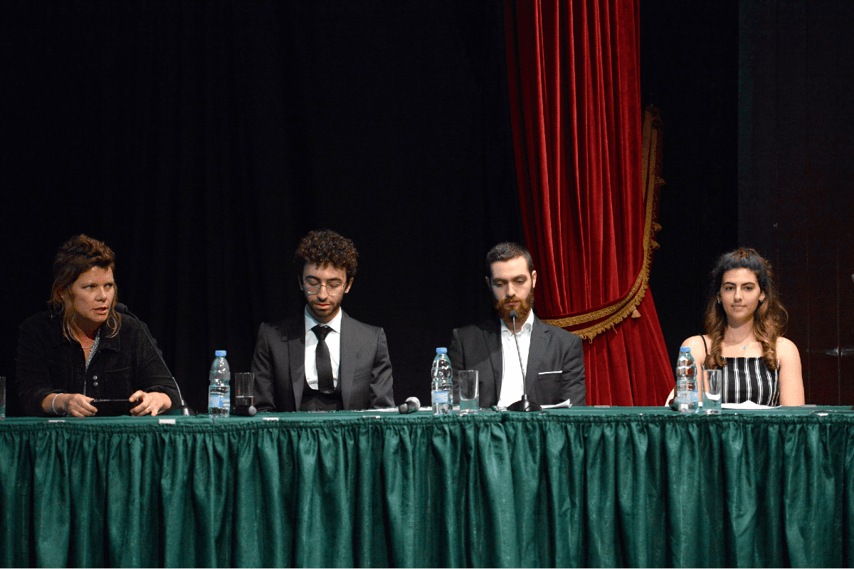 A photo of three student panelists with faculty member Gretchen King.